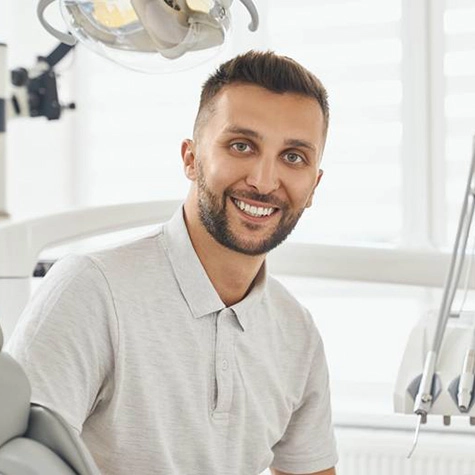 Bearded man in dental chair smiling