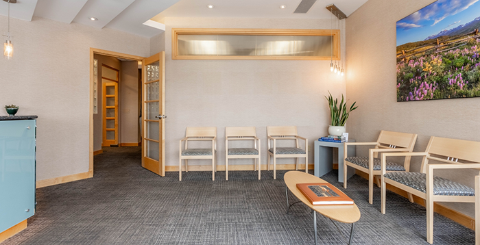 Greenwood Village dental office waiting room with multiple chairs and a table