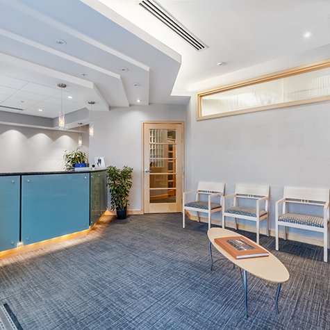 Chairs, table, and front desk in waiting room