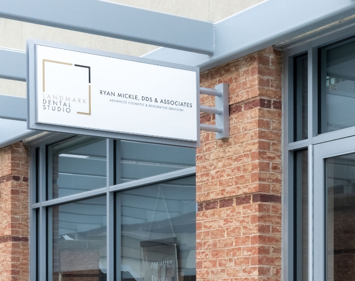 Outside shot of dental office with sign for Landmark Dental Studio