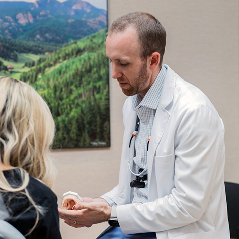 Dr. Mickle showing model of teeth to patient