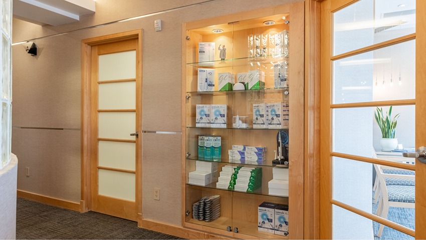 Dental products on glass shelves in hallway