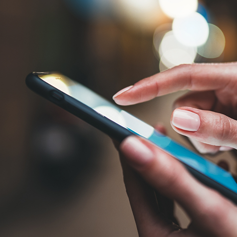 Close-up of hands holding phone